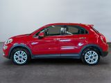 the red fiat suv is parked in a room with a white wall