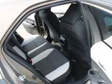 two seats in the back of a car that are black and white