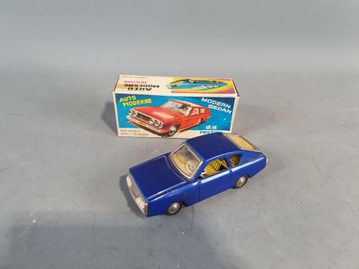 a blue toy car next to a box on a table