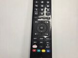 a remote control sitting on a table next to a laptop