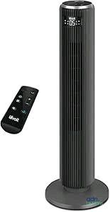 a black tower fan sitting next to a remote control