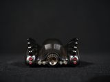 close up of a toy batmobile sitting on a black surface