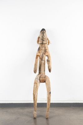 an image of a wooden sculpture of a man holding a baby