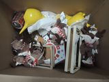 a cardboard box filled with stuffed animals and construction hats