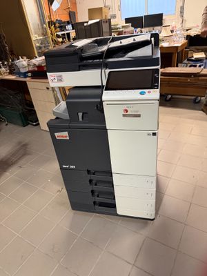 a stack of multi - function printers sitting on the floor