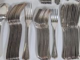 many forks and spoons laid out on the table