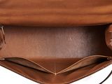 the inside of a brown leather purse with a strap