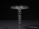 a close up of a clear glass table with a black background