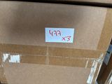 a cardboard box with a sticker on it sitting on the floor