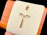 a small cross on a wooden stand on a black background