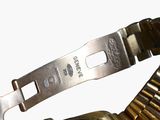 a close up of a watch with a metal band