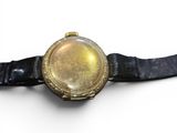 a watch that is sitting on a black strap