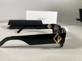 the sunglasses are black and have gold accents on them
