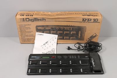 a box of electronic equipment on a table next to a keyboard