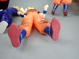 three figurines of children laying down on a table