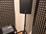 two speakers and a mixer in the corner of a room