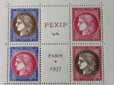 a close up of a stamp with four different faces on it