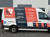 a van that is parked in front of a building