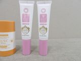 two tubes of sunscreen cream and a tube of sunscreen cream on a table