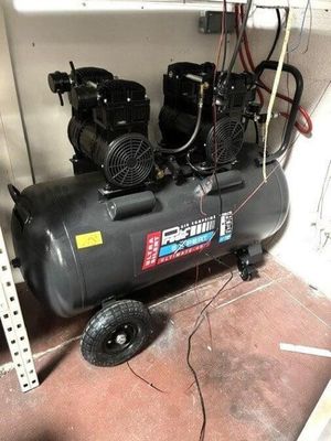 two air compressors sitting on a shelf in a room
