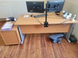 a desk with two monitors and a keyboard on it