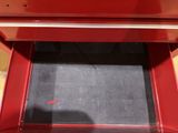 a red oven with a black counter top and a red stove top