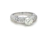 an image of a diamond engagement ring with a diamond center stone