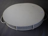 a white table with a metal basket on it
