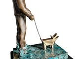 bronze statue of a man with a dog on a leash