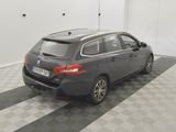 the back end of a grey car parked on a checkered floor