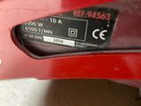 a close up of a red car with a sticker on the side of it