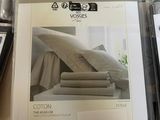 a lot of sheets and pillows on the table