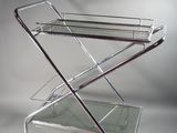 an image of a chrome and glass bar cart
