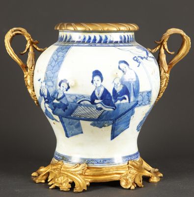 a blue and white vase with gold decoration on it