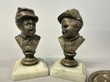 pair of antique bronze busts of two men on marble bases