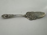 a silver spoon with a floral design on it