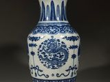 a blue and white vase sitting on a table