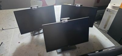 three monitors sitting on top of each other in a room