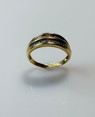 a close up of a gold ring on a white surface