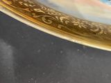 a gold plate with a blue and white design on it