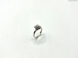 an image of a diamond ring on a white surface