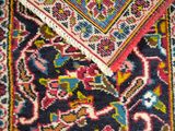 a close up of a rug with a colorful design on it