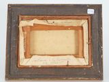 an old picture frame with a piece of paper and a piece of paper in it