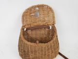 an image of a wicker basket with a handle on a white background