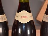 several bottles of wine are lined up on a table