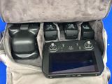 a camera and a tablet in the back of a bag