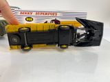 a hand holding a toy truck that is next to a box