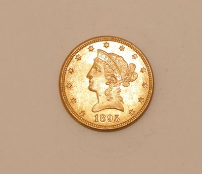 a close up of a gold coin with a woman ' s head on it