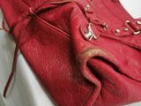 a red purse sitting on top of a white table