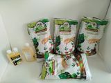 three bags of food sitting on a shelf next to a bottle of liquid